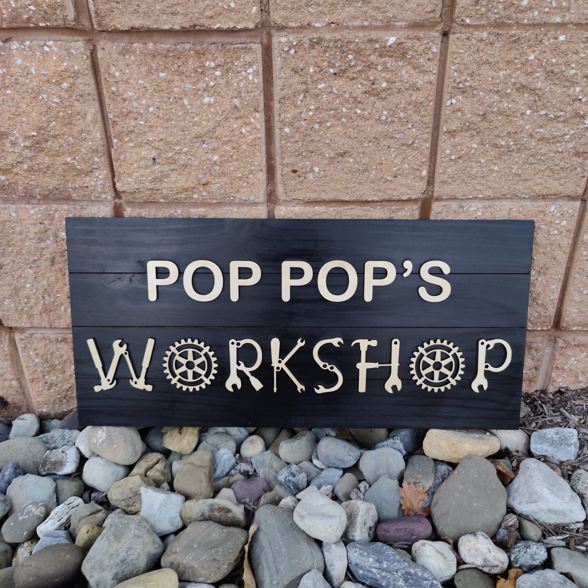 Personalized wood workshop sign with raised 3D lettering on a stained pine board for a garage or man cave