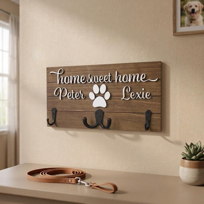 Home sweet home wood key and leash holder with 3D names around a raised white paw and black metal wall hooks